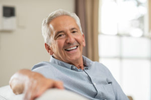 a man smiling with a full arch of implants on his top